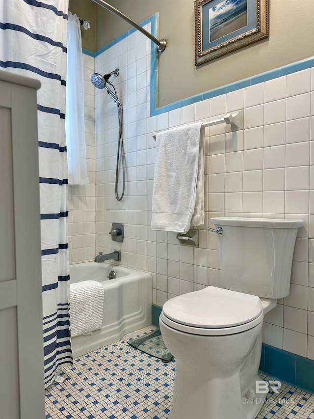 bathroom with tile patterned floors, tile walls, and toilet