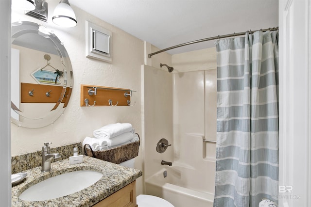 full bathroom with toilet, a textured wall, shower / tub combo with curtain, and vanity