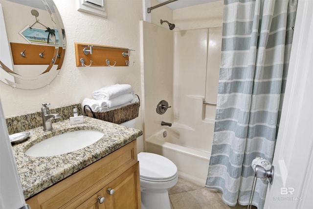 full bath with a textured wall, toilet, vanity, tile patterned floors, and shower / bath combo