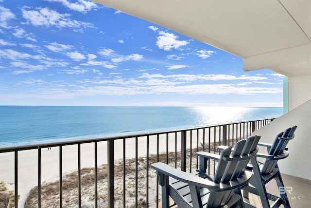 balcony featuring a water view and a view of the beach