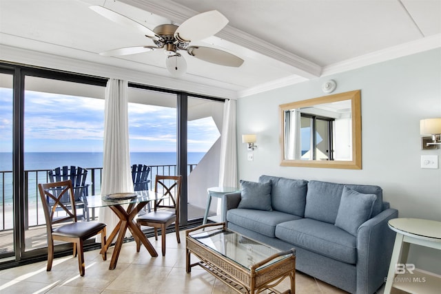 living area with a ceiling fan, a water view, crown molding, and light tile patterned floors