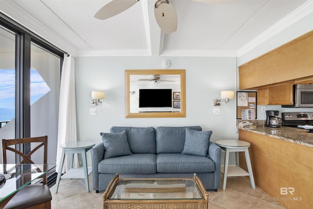 living area with ceiling fan, ornamental molding, baseboards, and light tile patterned flooring