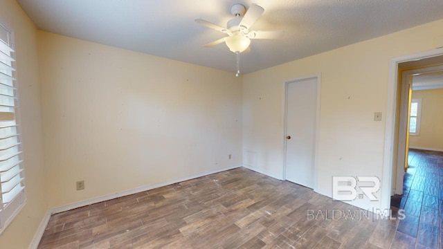 unfurnished room with ceiling fan and wood-type flooring