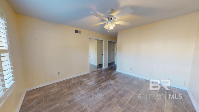 unfurnished bedroom with dark hardwood / wood-style floors and ceiling fan