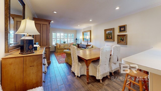 dining area with dark hardwood / wood-style flooring and crown molding