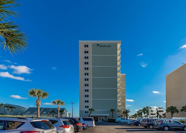 view of building exterior with uncovered parking