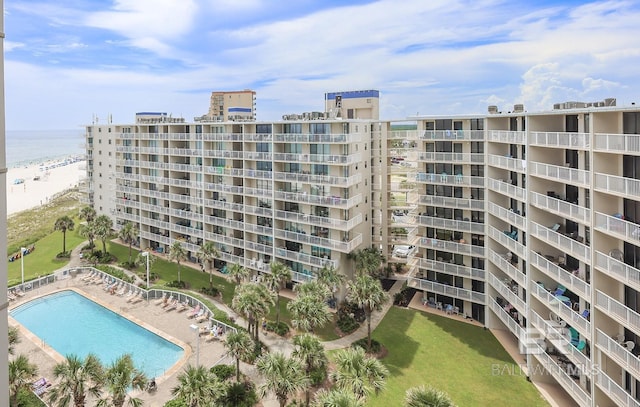 view of building exterior featuring a view of city and a community pool