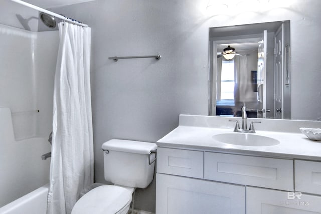 bathroom with shower / bath combo, vanity, toilet, and ceiling fan