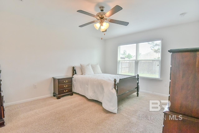 bedroom with baseboards, ceiling fan, and light colored carpet