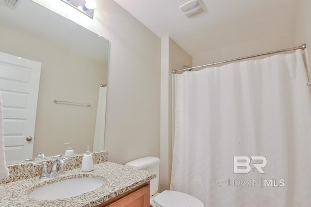 bathroom featuring curtained shower, vanity, toilet, and visible vents