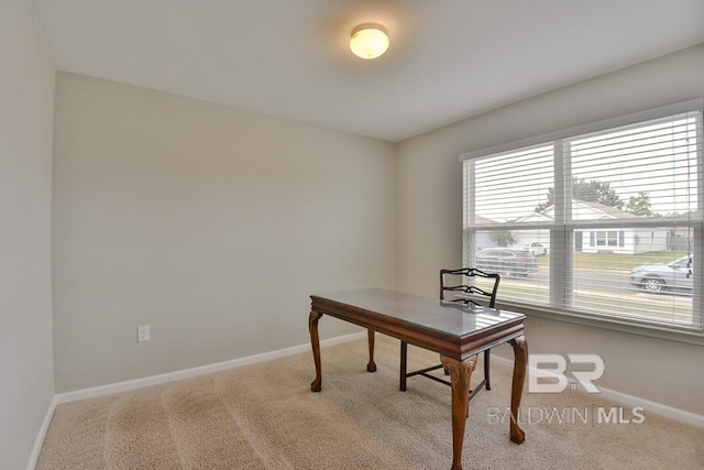 carpeted office featuring baseboards