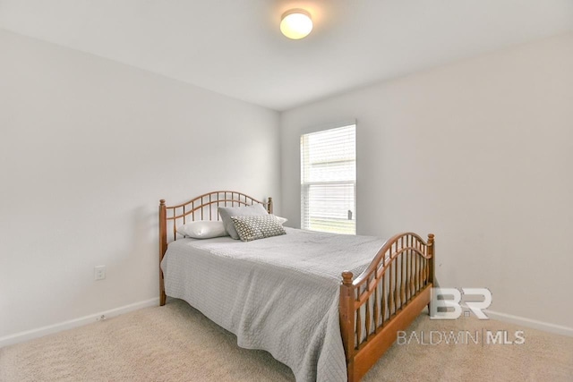 carpeted bedroom featuring baseboards