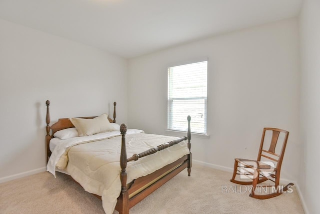 bedroom featuring baseboards and light colored carpet
