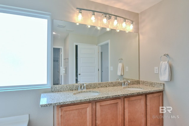 full bathroom featuring double vanity and a sink