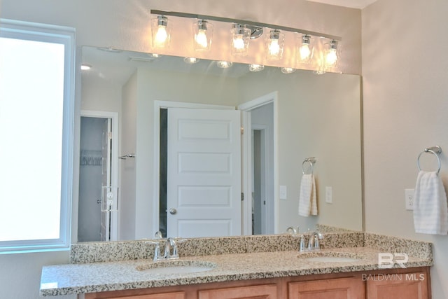 full bath with double vanity and a sink