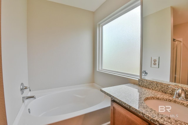 bathroom with a bath and vanity