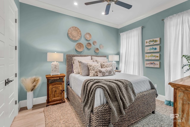 bedroom with ornamental molding, light hardwood / wood-style floors, and ceiling fan