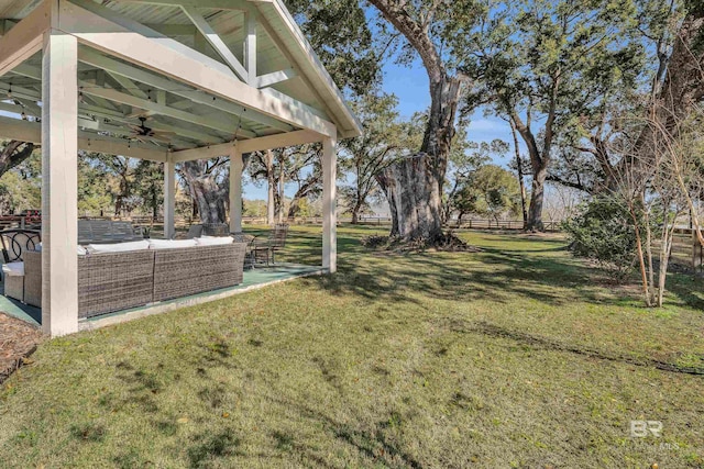 view of yard featuring a patio area, outdoor lounge area, and ceiling fan