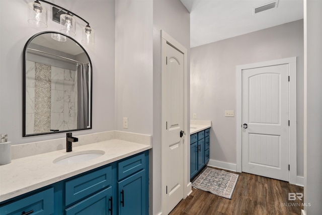 bathroom featuring a shower with shower curtain, wood-type flooring, and vanity