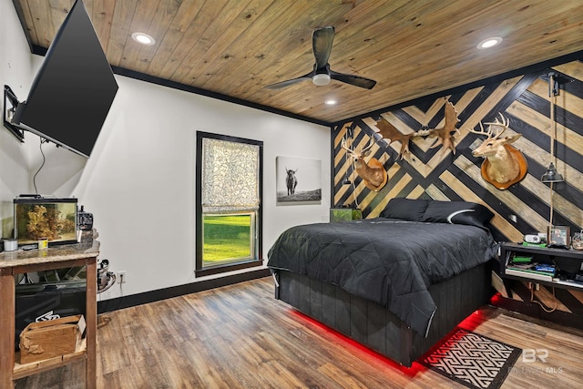 bedroom featuring ornamental molding, hardwood / wood-style flooring, ceiling fan, and wooden ceiling