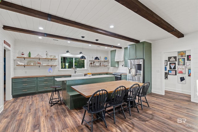 kitchen with dark hardwood / wood-style floors, green cabinets, beam ceiling, and appliances with stainless steel finishes