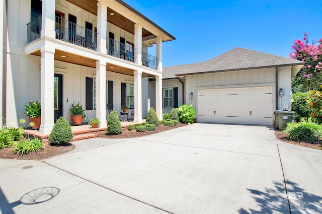 view of front facade featuring a garage and a balcony