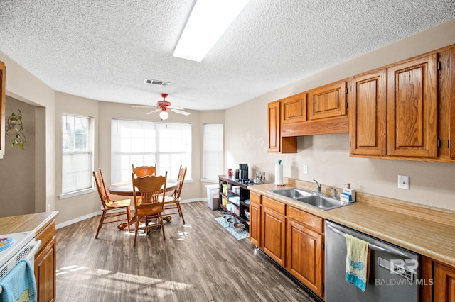 kitchen with stove, dark hardwood / wood-style flooring, stainless steel dishwasher, ceiling fan, and sink