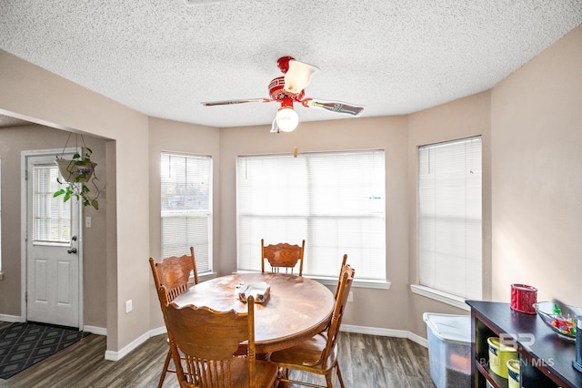 dining space featuring dark hardwood / wood-style floors, a healthy amount of sunlight, a textured ceiling, and ceiling fan