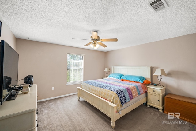 bedroom featuring carpet flooring, ceiling fan, and a textured ceiling