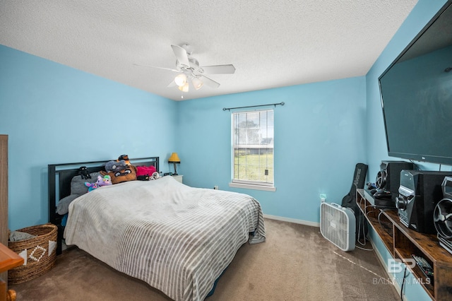 carpeted bedroom featuring a textured ceiling and ceiling fan