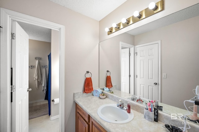 bathroom featuring vanity and a textured ceiling