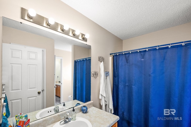 bathroom featuring vanity, toilet, and a textured ceiling