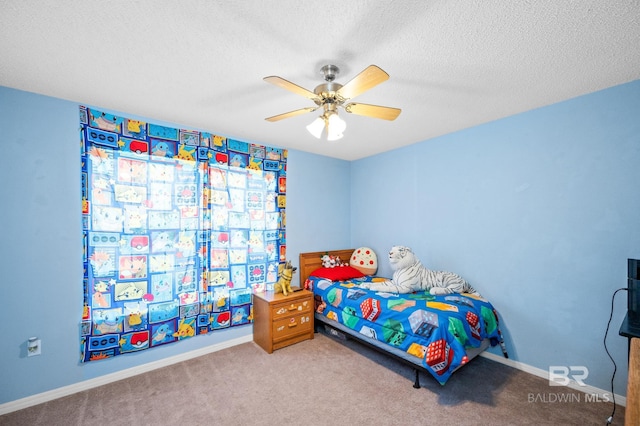 bedroom with ceiling fan, carpet, and a textured ceiling