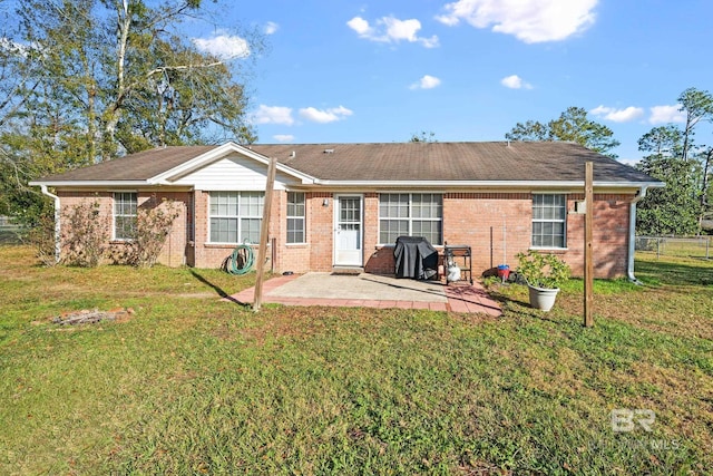 back of house featuring a yard and a patio