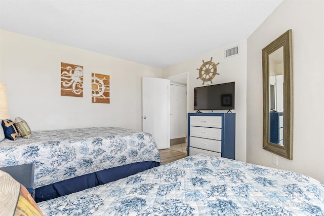 bedroom with visible vents and wood finished floors