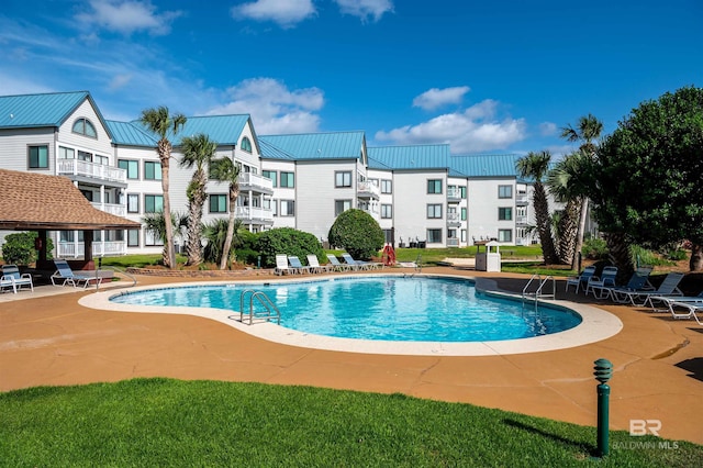 community pool featuring a patio area and a residential view