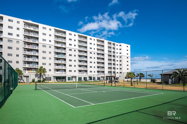view of tennis court featuring fence and community basketball court