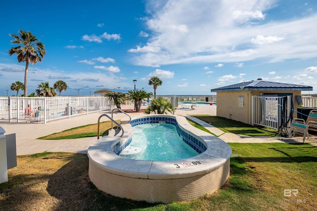pool featuring a lawn and fence