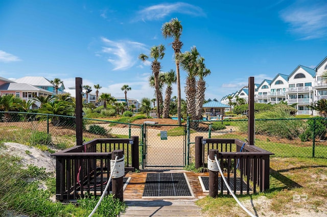wooden deck featuring a gate, fence, and a residential view