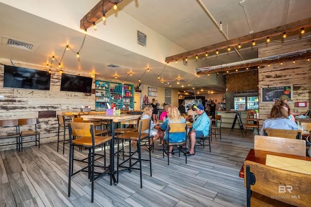 dining space featuring visible vents, wood finish floors, and track lighting