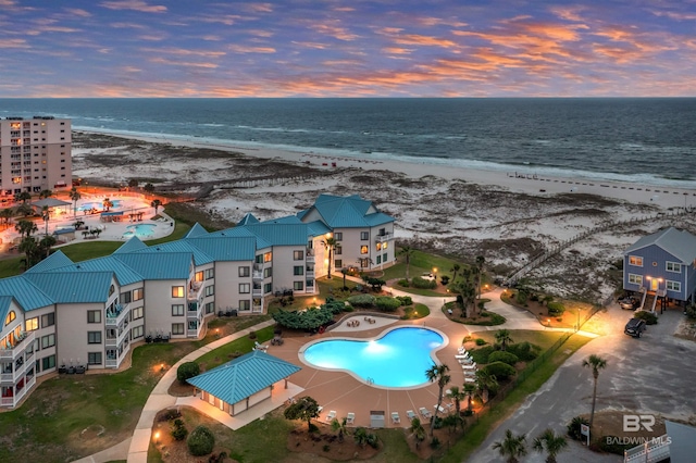 birds eye view of property featuring a water view and a view of the beach