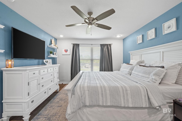bedroom featuring dark wood-type flooring and a ceiling fan