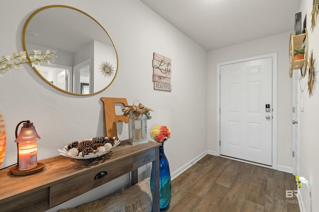 entryway with dark wood-style flooring and baseboards