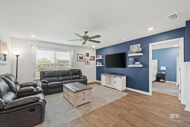 living area featuring recessed lighting, visible vents, light wood-type flooring, and a ceiling fan