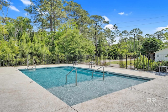community pool with fence and a patio area