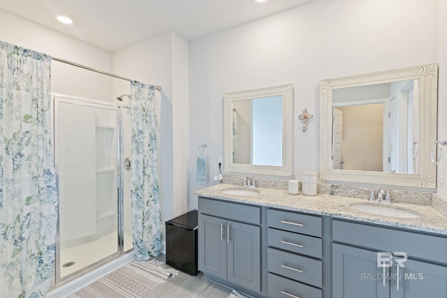 bathroom with double vanity and walk in shower