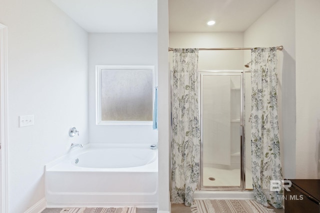 bathroom featuring separate shower and tub