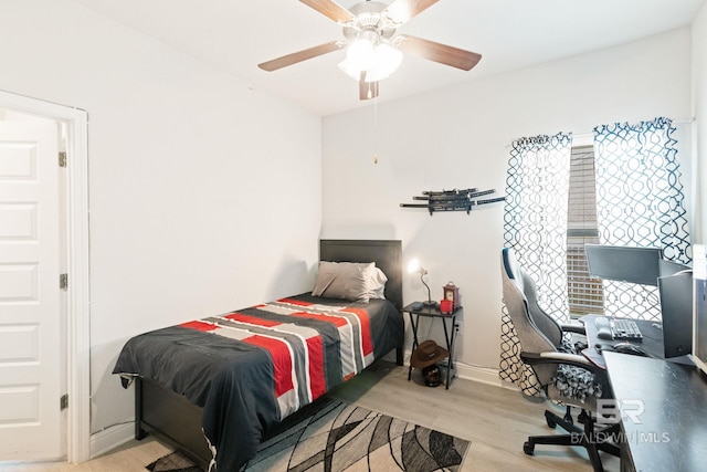 bedroom with light hardwood / wood-style flooring and ceiling fan