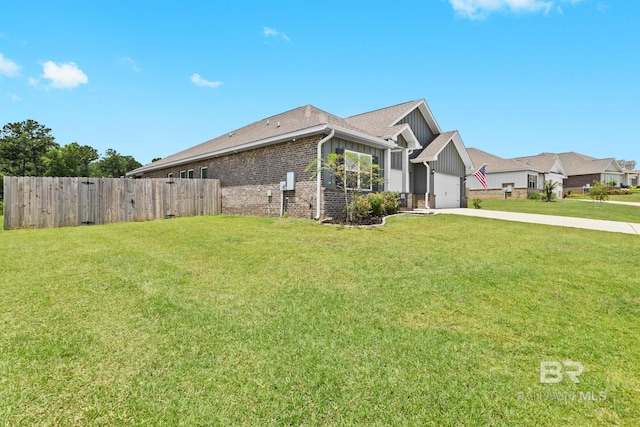 view of front of house featuring a garage and a front lawn