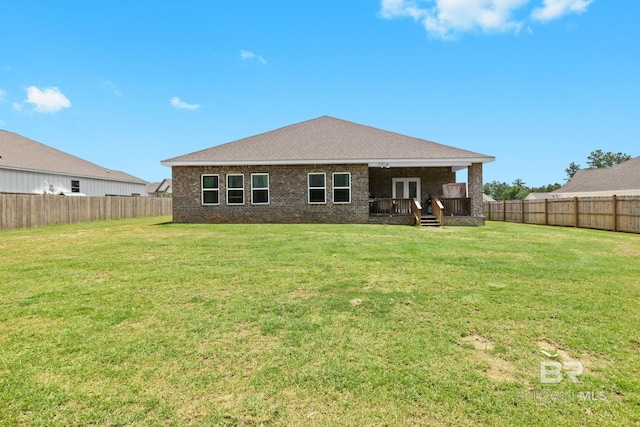 rear view of property with a lawn